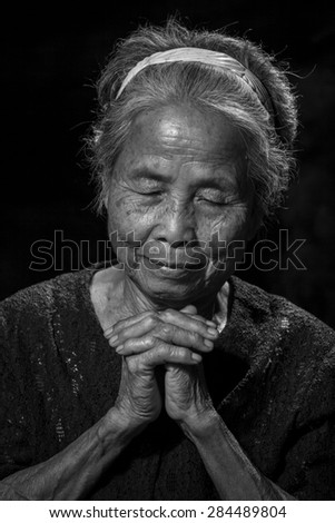 Portrait of a senior woman praying, Black and White colour