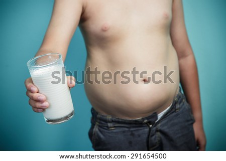 Obese boy holding a glass of milk, Healthy and lose weight concept