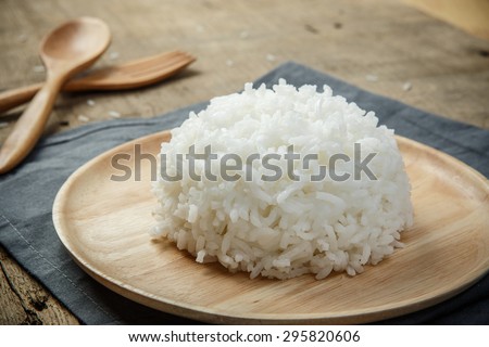 Close-up view of cooked white rice with napery and wooden spoon - soft focus