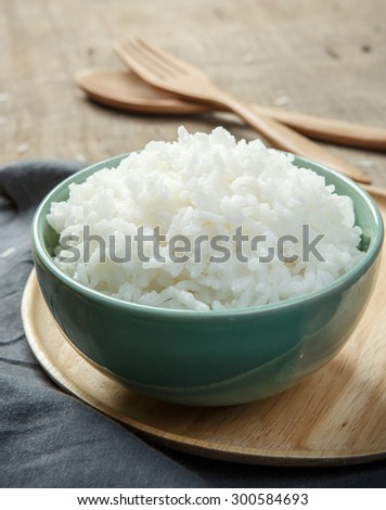 Jasmine rice in a rice bowl on wood table - soft focus