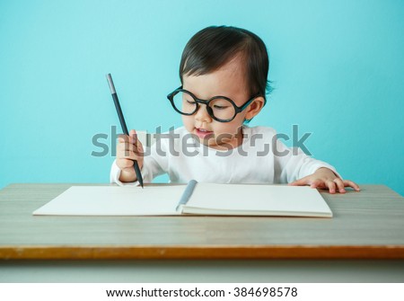 Baby happy wearing glasses on the table, new family and love concept (soft focus on the eyes)