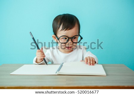 Baby happy wearing glasses on the table, new family and love concept (soft focus on the eyes)