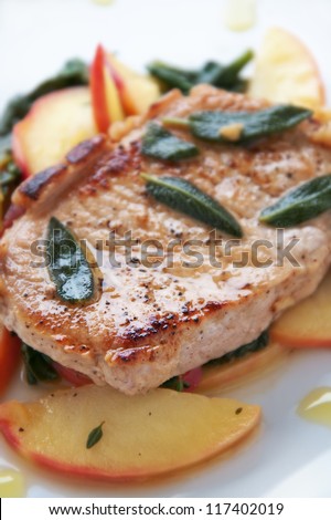 Golden pork chop with warm apple and green salad
