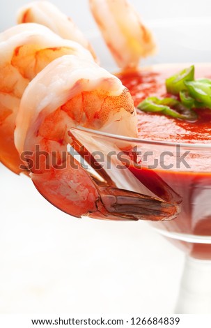 Fresh shrimp around martini glass with cocktail sauce