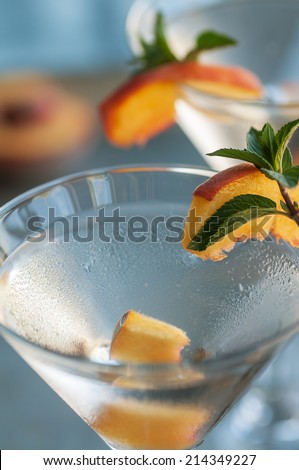 Refreshing Summer cocktails vodka martinis with fresh peaches