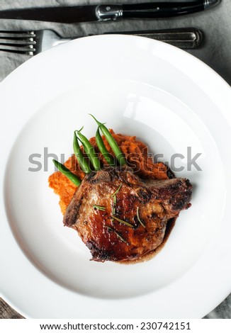 Beautifully roasted pork chop with green beans and sweet potato puree