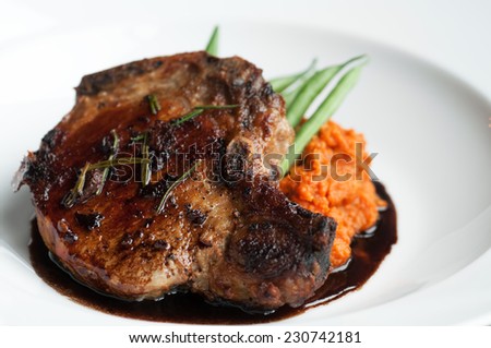 Beautifully roasted pork chop with green beans and sweet potato puree