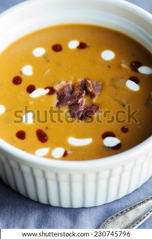 Sweet potato soup with bacon garnish hot sauce and creme fraiche