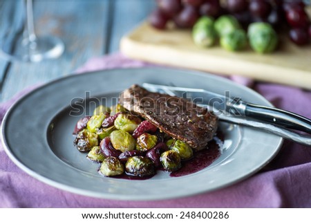 Flanks steak with roasted brussels sprouts, grapes and red wine sauce