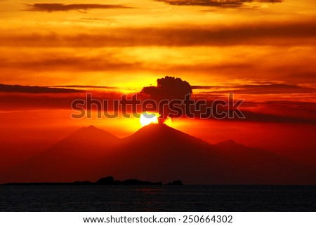 smoking volcano on sunset