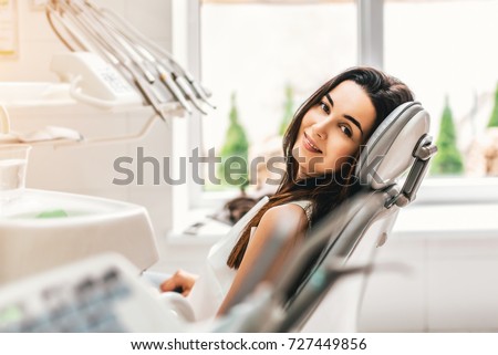 Happy dental patient in the dental chair