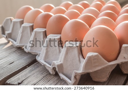 Eggs in paper tray on wood