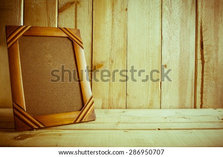 Antique photo frame on wooden table over wood background, Still life style