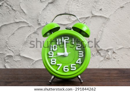 Clock on Wooden Floor with Cement Background