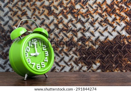 Clock on Wooden Floor with Steel Plat Grunge Background