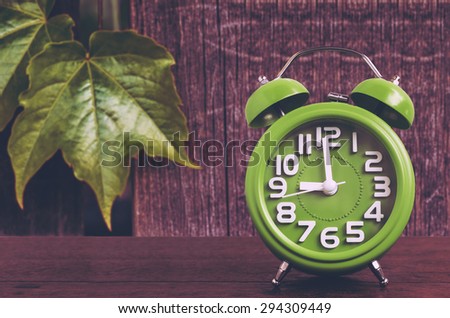 Clock on Wooden Floor with Leaf and Wood Background , Vintage Style