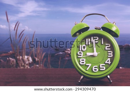 Clock on Wooden Floor with Blue Sky and Hillock  Background , Vintage Style