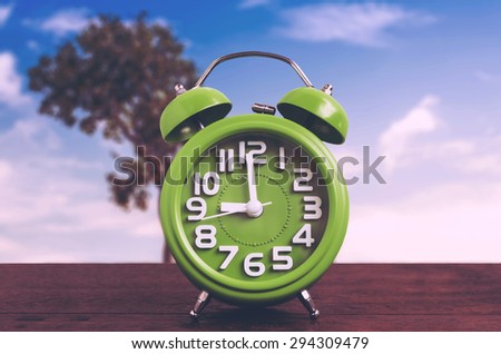 Clock on Wooden Floor with Tree and Blue Sky Background , Vintage Style