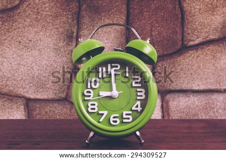 Clock on Wooden Floor with Stone Background , Vintage Style