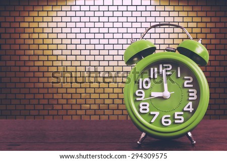 Clock on Wooden Floor with Yellow Brick Wall  Background , Vintage Style