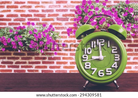 Clock on Wooden Floor with Flower and Brick Wall Background , Vintage Style