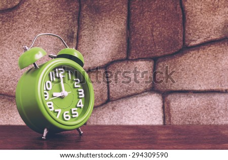 Clock on Wooden Floor with Stone Background , Vintage Style