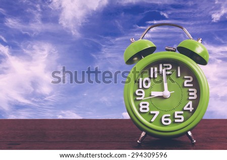 Clock on Wooden Floor with Blue Sky Background , Vintage Style
