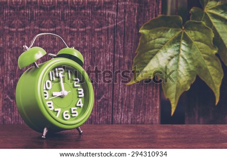 Clock on Wooden Floor with Leaf and Wood Background , Vintage Style