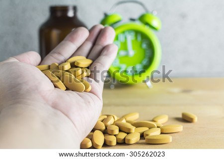 Handful of medicine on wood background