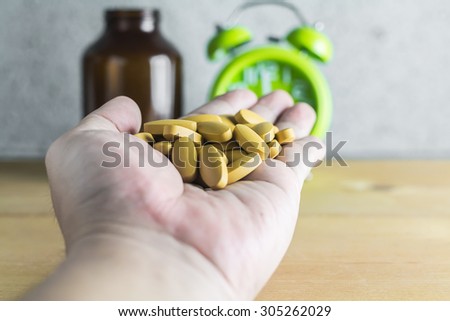 Handful of medicine on wood background