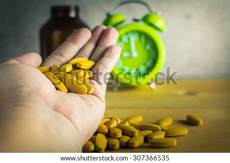 Handful of medicine on wood background , antique style