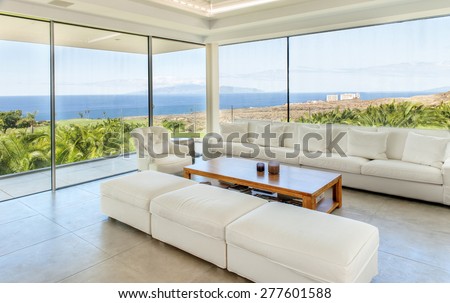 White living room in the modern villa with sea view