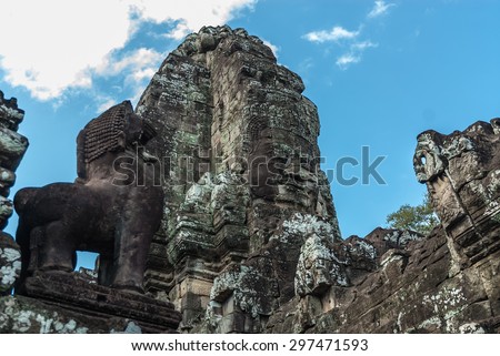 tower with the lokeshvara face smiling, with the facial features of Jayavarman VII, and lion guard in the archaeological place of the bayon in siam reap, cambodia