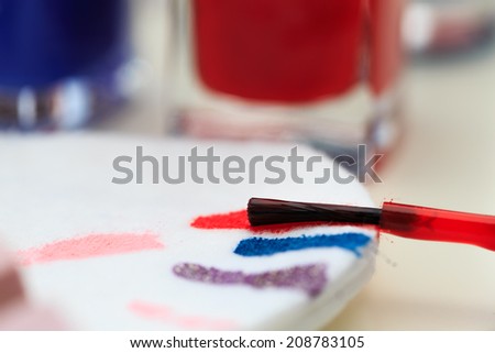 Macro shot of nail polish brush on cotton pad