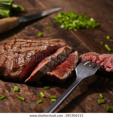 Cooked steak with  chopped herbs rustic