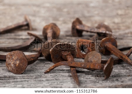 Antique Rusty Nails on a old wood background