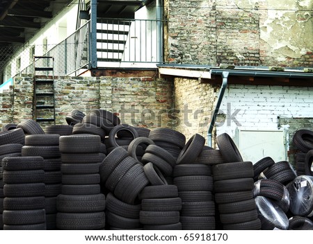 Wall of old car tires with old Brick Wall in the background
