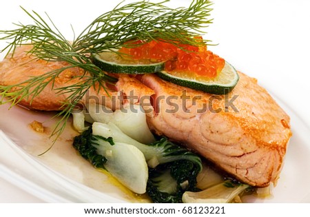Broiled salmon steak with spinach and red caviar