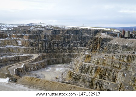 Snow covered stone quarry in the winter with all the tools and buildings ready to work