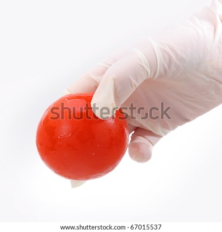 The hand is holding a red ball