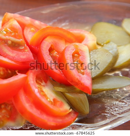 Healthy food. The tomatoes and cucumbers on the glass plate