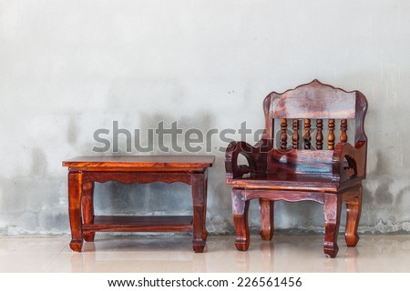 wood chair and table furniture and grunge concrete wall backgroud