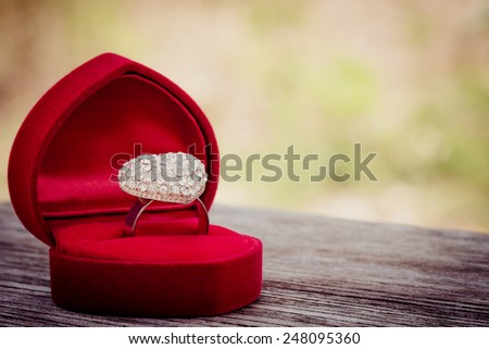 heart dimond love ring in velvet on wood and blur background