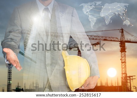 businessman with handshake to cooperation and construction building background