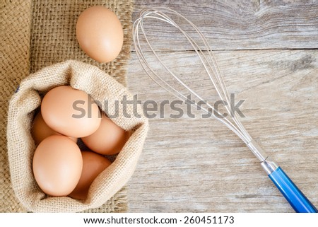 chicken egg raw food on grain wood background