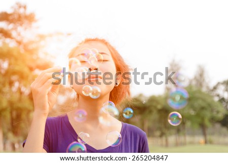 beautiful young woman blowing bubble outdoor happy lifestyle