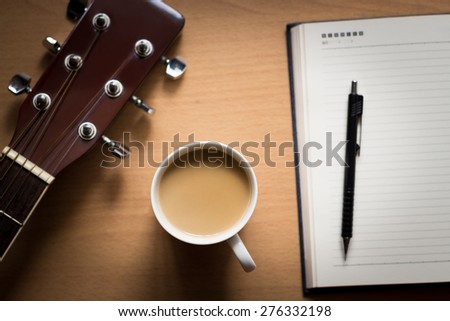 hot coffee with guitar and notepad on table break time for thinking idea