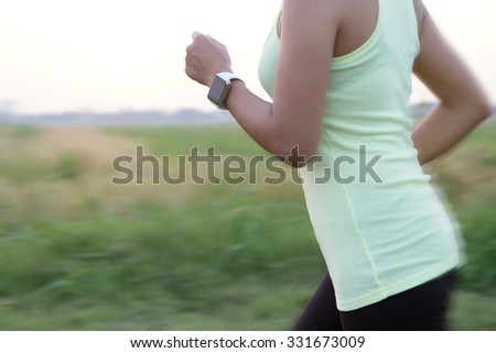 women wear hand watch running motion blur concept