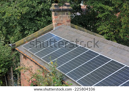 Solar panels on an old house showing the desire for sustainable energy and mixing old with new