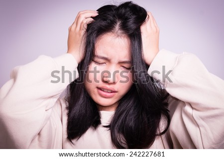 A woman headache in a bad hair day.